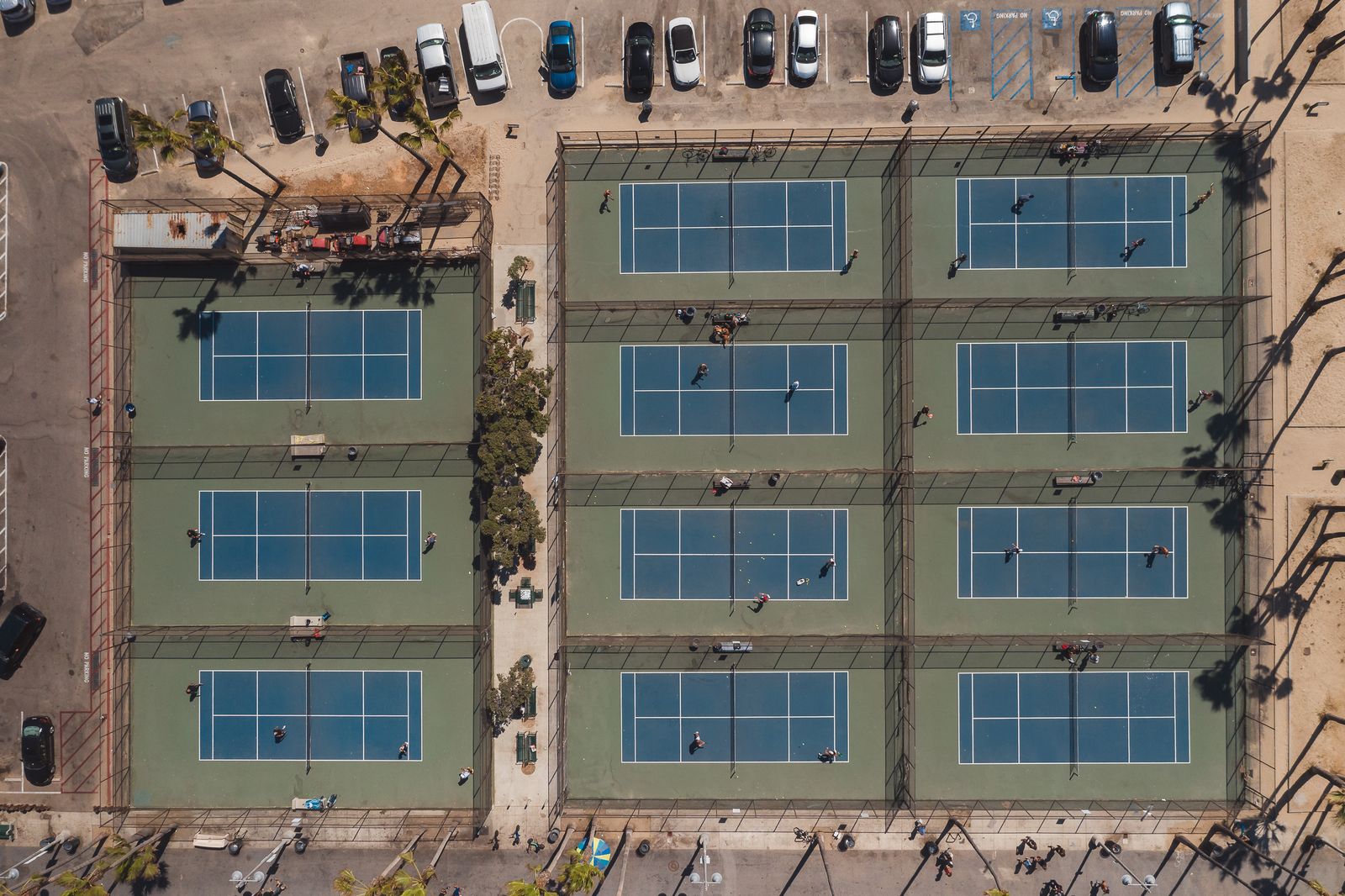 Aerial view of multiple tennis courts in an outdoor sports complex.